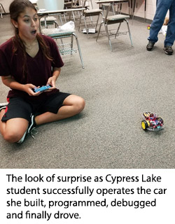 The look of surprise as Cypress Lake student successfully operates the car she built, programmed, debugged and finally drove