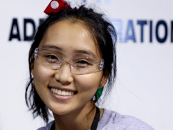 Image shows a girl smiling at the camera