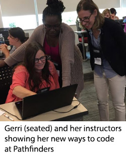 Gerri (seated) and her instructors showing her new ways to code at Pathfinders