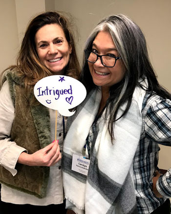 Image shows two female of the educators smiling at the camera