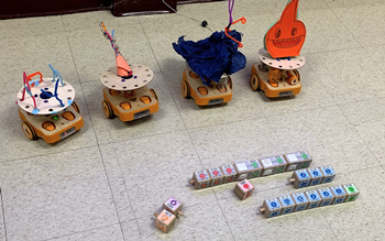 Image shows 4 small robots built by educators for learning to teach their students this series of skills